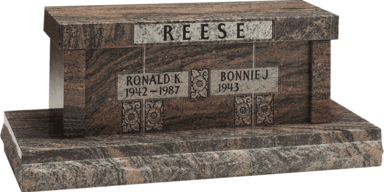 Polished granite bench-style memorial engraved with the name “REESE,” featuring individual name plaques including “Ronald K. 1942–1987” and “Bonnie J. 1943–,” on a solid stone base.